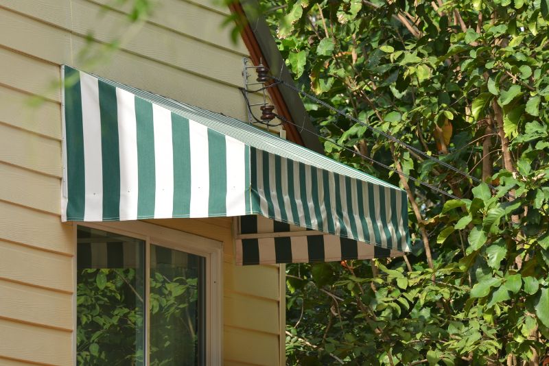 white and green stripes awning over a window